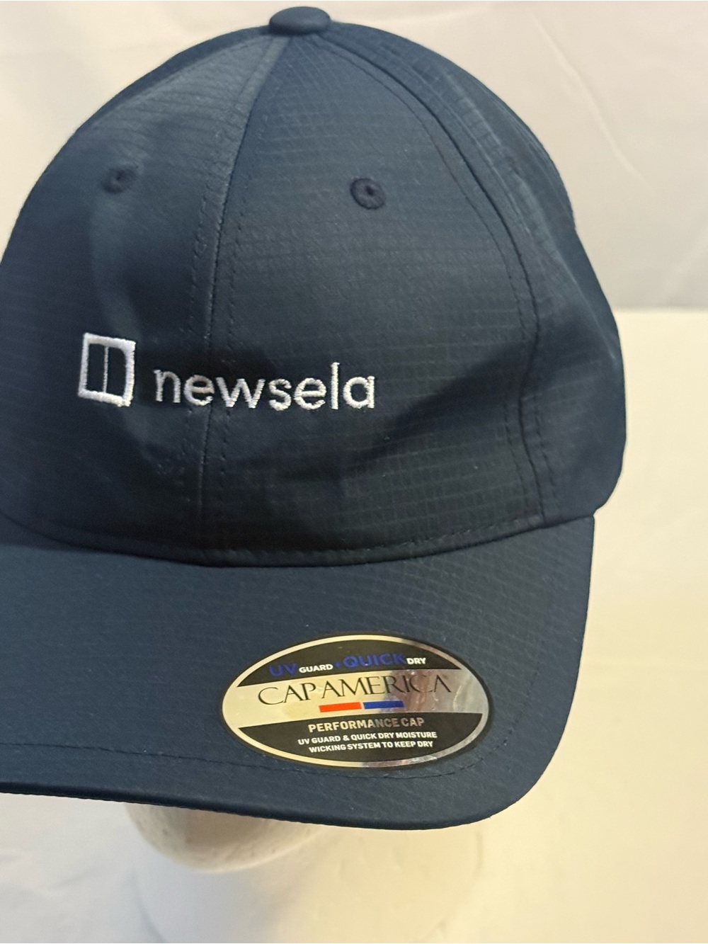 Newsela Navy Performance Cap